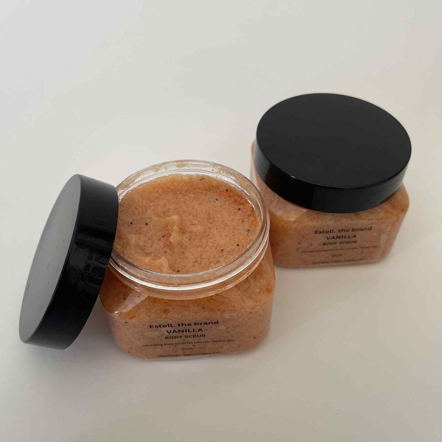 Two jars of a brown substance with black lids on a white background