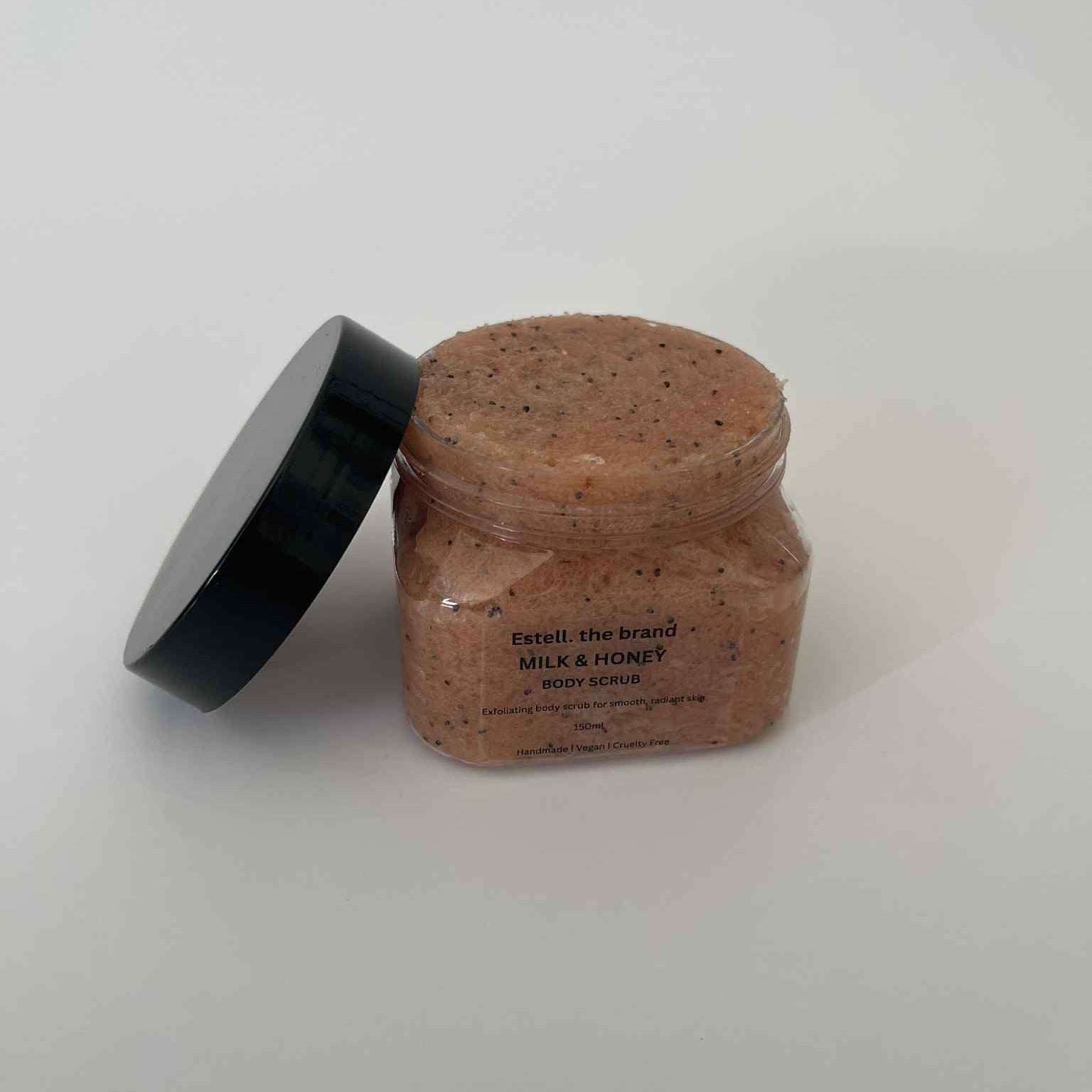 Jar of brown scrub with black lid on a white background