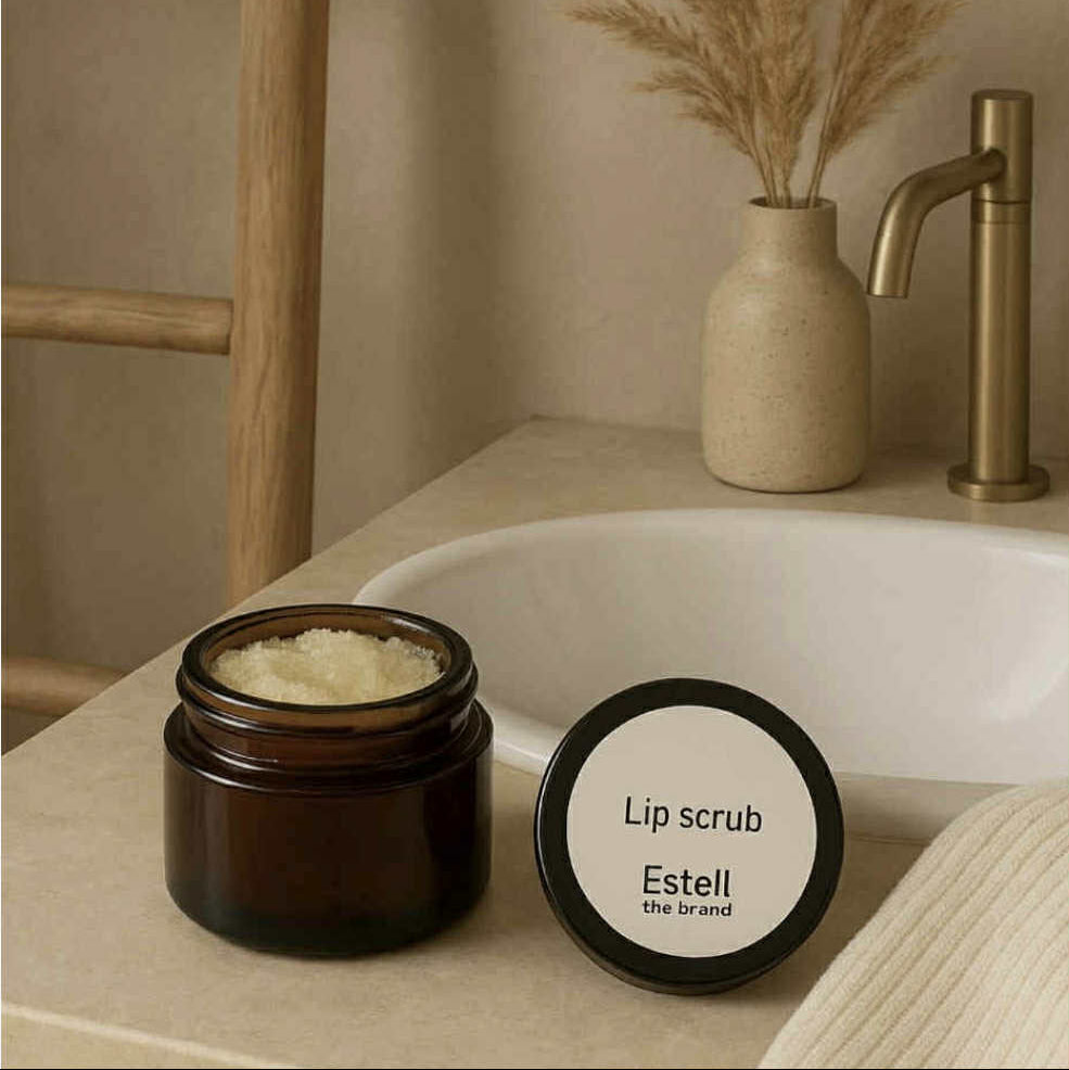 Lip scrub container with lid labeled 'Estell' on a bathroom counter.